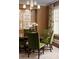 Dining room features green chairs, a round table, a modern chandelier, and elegant decorations at 2909 Redding Road Northeast, Atlanta, GA 30319