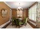 Dining room with wood table, green chairs, and a modern chandelier at 2909 Redding Road Northeast, Atlanta, GA 30319