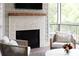 Beautiful fireplace with stone surround and wood mantel on screened porch overlooking the backyard at 2909 Redding Road Northeast, Atlanta, GA 30319