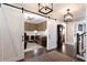 Elegant foyer with sliding barn doors, hardwood floors, and decorative lighting fixtures at 2909 Redding Road Northeast, Atlanta, GA 30319