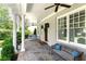 Inviting front porch with stone floor, white columns, and ample seating at 2909 Redding Road Northeast, Atlanta, GA 30319