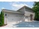 Spacious three car garage in painted brick and shaker siding, and concrete driveway at 2909 Redding Road Northeast, Atlanta, GA 30319