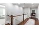 Hallway with hardwood floors and white railings leading to a room with comfortable seating at 2909 Redding Road Northeast, Atlanta, GA 30319
