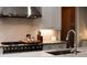 Close up of kitchen featuring stainless steel stove and fixtures, tile backsplash, and marble countertops at 2909 Redding Road Northeast, Atlanta, GA 30319
