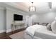 Spacious bedroom with modern lighting, hardwood floors, and seating area next to the bed at 2909 Redding Road Northeast, Atlanta, GA 30319