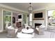 Charming screened porch with a fireplace, mounted TV, and sliding glass doors to the indoors at 2909 Redding Road Northeast, Atlanta, GA 30319
