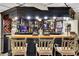 Close up view of a finished basement bar with seating and mirrorred shelves filled with liquor at 3244 Beechwood Se Dr, Marietta, GA 30067