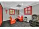 Basement dining area with a small table, chairs, and red shutters over windows at 3244 Beechwood Se Dr, Marietta, GA 30067