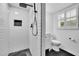 Modern tiled bathroom featuring sleek fixtures, a rainfall showerhead, and ample lighting at 3244 Beechwood Se Dr, Marietta, GA 30067