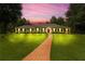Stunning ranch-style home with a lush green lawn and a striking red front door at sunset at 3244 Beechwood Se Dr, Marietta, GA 30067