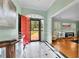 Elegant foyer with black and white tile flooring, a vibrant red door, and views into the living area at 3244 Beechwood Se Dr, Marietta, GA 30067
