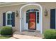 Close-up of the front door featuring an arched entryway, decorative sidelights, and vintage-style sconces at 3244 Beechwood Se Dr, Marietta, GA 30067