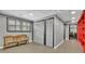 Hallway with grey walls, bench seating, and doors, with a peek into a red room at 3244 Beechwood Se Dr, Marietta, GA 30067