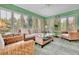Cozy sunroom featuring wicker furniture, shutters, and views of the outdoors at 3244 Beechwood Se Dr, Marietta, GA 30067