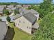 Aerial view of the property showcasing the backyard, surrounding trees, and neighborhood at 4480 Egret Ave, Cumming, GA 30041
