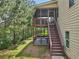 Backyard view with staircase to the covered patio and lush green lawn at 4480 Egret Ave, Cumming, GA 30041