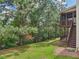 Exterior shot of the home's backyard with covered patio and lush green lawn at 4480 Egret Ave, Cumming, GA 30041