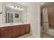 Bathroom featuring a double sink vanity with a shower and bathtub with a curtain at 4480 Egret Ave, Cumming, GA 30041