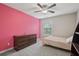 Bedroom features a large bureau, ceiling fan, and natural light from the window at 4480 Egret Ave, Cumming, GA 30041