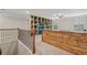 Upstairs bonus room with custom built-in shelving, a desk, and a ceiling fan at 4480 Egret Ave, Cumming, GA 30041