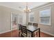 Cozy dining area featuring hardwood floors, a modern chandelier, and natural light at 4480 Egret Ave, Cumming, GA 30041