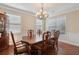 Bright dining area with wooden table and chairs; natural light fills the room through large windows at 4480 Egret Ave, Cumming, GA 30041