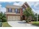 Beautiful two-story brick home with a well-maintained lawn and attached two-car garage at 4480 Egret Ave, Cumming, GA 30041