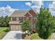 Beautiful two-story brick home featuring a manicured lawn and two-car garage at 4480 Egret Ave, Cumming, GA 30041