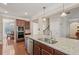 Open-concept kitchen island features granite countertops, stainless steel sink, and stainless steel dishwasher at 4480 Egret Ave, Cumming, GA 30041