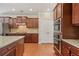 Spacious kitchen showcases wood cabinets, stainless steel appliances, and gleaming hardwood floors at 4480 Egret Ave, Cumming, GA 30041