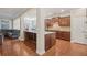 Open-concept kitchen with granite island and stainless steel appliances, flowing into living area at 4480 Egret Ave, Cumming, GA 30041