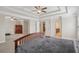 Spacious main bedroom with tray ceilings, ceiling fan, and adjoining sitting area and bath at 4480 Egret Ave, Cumming, GA 30041