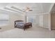 Spacious main bedroom with a tray ceiling, ceiling fan, and ample natural light at 4480 Egret Ave, Cumming, GA 30041