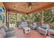 Relaxing screened porch featuring comfortable seating and a ceiling fan at 4480 Egret Ave, Cumming, GA 30041
