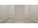 Carpeted walk-in closet with built-in shelving and ample storage space at 4480 Egret Ave, Cumming, GA 30041