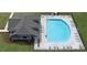 Aerial view of a community pool with lounge seating and a community building at 1346 Riverstone Rd # 107, Jonesboro, GA 30238