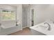 Bathroom with a soaking tub, a walk-in shower, and double sinks at 1346 Riverstone Rd # 107, Jonesboro, GA 30238