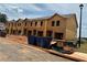 Exterior of a new construction townhome featuring unfinished siding and blue bins at 1346 Riverstone Rd # 107, Jonesboro, GA 30238