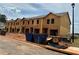 Exterior of a new construction townhome featuring unfinished siding and blue bins at 1346 Riverstone Rd # 107, Jonesboro, GA 30238
