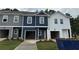 Modern townhome exteriors with attached garages, new lawns, and coordinated color schemes at 1346 Riverstone Rd # 107, Jonesboro, GA 30238