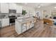 Stylish kitchen boasts an island with bar seating, stainless steel appliances, and an open floorplan to the living area at 1346 Riverstone Rd # 107, Jonesboro, GA 30238