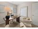 Bright office space featuring a dark wood desk with art and seating at 1346 Riverstone Rd # 107, Jonesboro, GA 30238