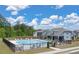 Community pool area with chairs, tables, and umbrellas, perfect for outdoor enjoyment at 1346 Riverstone Rd # 107, Jonesboro, GA 30238