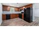 Basement kitchenette with wood cabinets, granite countertops, and black appliances at 2480 Washington Street Ext # 2482, Austell, GA 30106