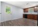 Finished basement kitchenette with wood vinyl floors, wooden cabinets, granite countertops, and black appliances at 2480 Washington Street Ext # 2482, Austell, GA 30106