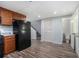 Basement kitchenette with wood cabinets, granite countertops, black fridge and access to the bathroom and backyard at 2480 Washington Street Ext # 2482, Austell, GA 30106