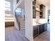 Stylish bar area with custom cabinetry, marble countertops, a wine refrigerator, and easy access to the staircase at 344 Michael Dr, Alpharetta, GA 30009