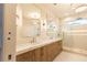 A luxurious bathroom with double vanity, wood cabinets, marble countertops and a frameless glass shower at 344 Michael Dr, Alpharetta, GA 30009