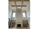A spacious living room with wood beams, built-in cabinets, fireplace, and large windows providing natural light at 344 Michael Dr, Alpharetta, GA 30009