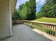 Side view of a wooden deck overlooking the green backyard and woods at 5619 Wandering Vine Se Ln, Mableton, GA 30126